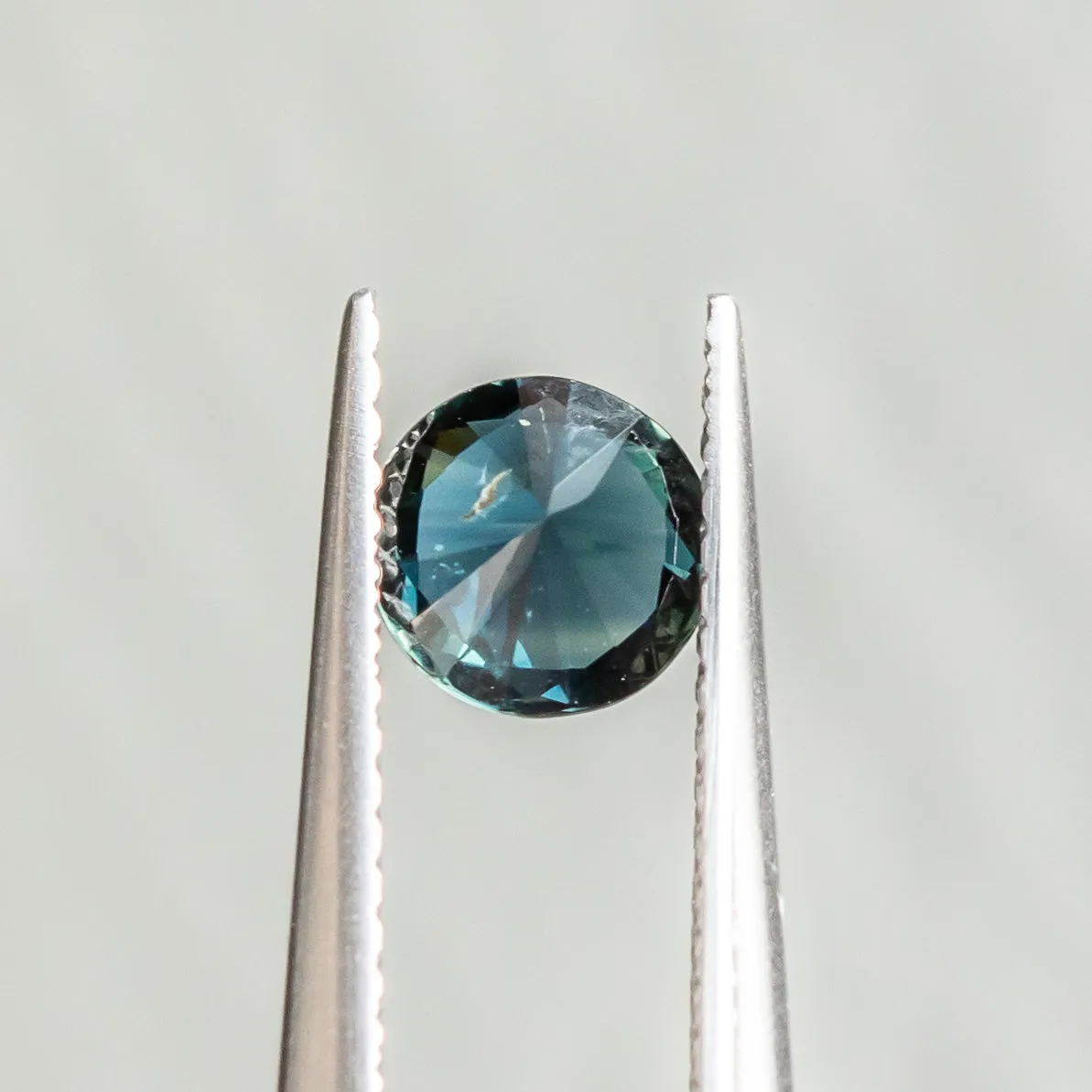 0.92CT ROUND NIGERIAN SAPPHIRE, TEAL, 5.95X5.85X3.44MM, UNTREATED